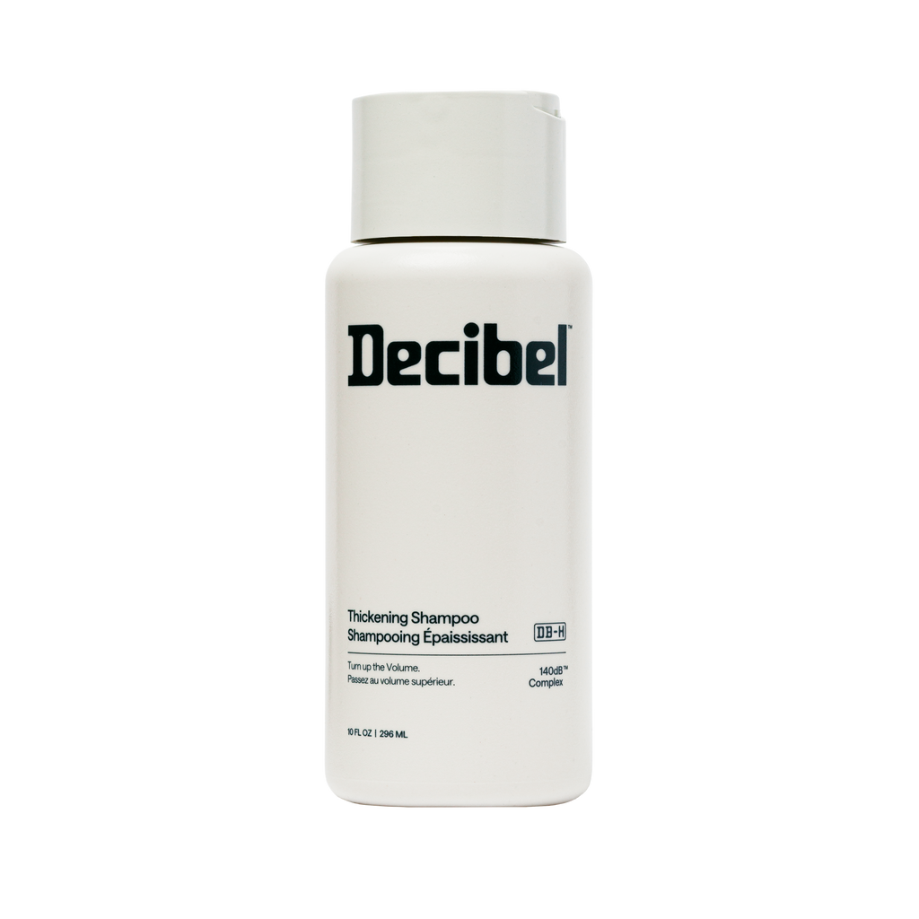 A white bottle of Decibel Thickening Shampoo with a matching white cap, shown against a plain white background.