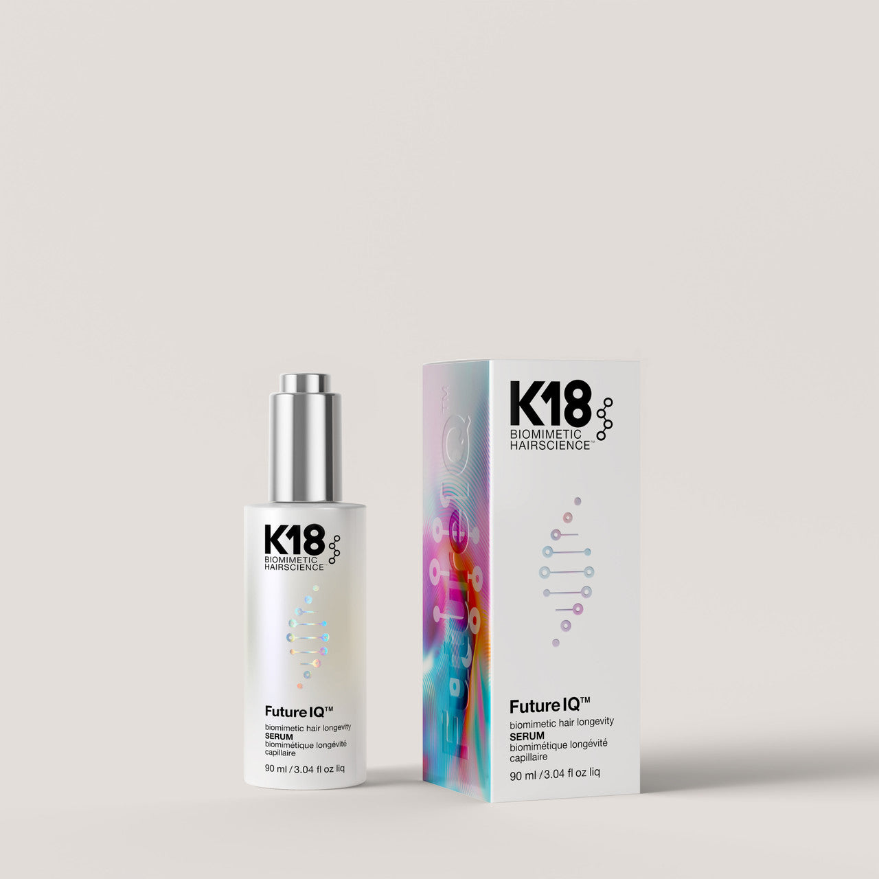 K18 Biologics FutureIQ hair serum bottle with a silver cap next to its colorful packaging box, set against a solid light beige background.